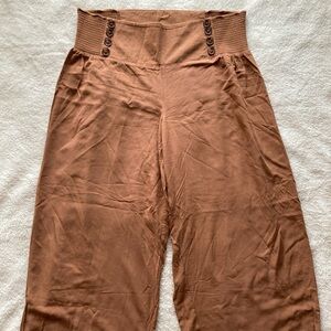 Brown flowy boho pants with elastic waist band and cute button details. Size L.